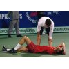 Juan Reque, an ATP trainer from Spain, talks to Croatia's Goran Ivanisevic as he collapses to the ground after damaging his knee during his first-round match with Russia's Andrei Stoliarov at the Dubai Open Tennis Championships, Monday, Feb. 24, 2003 in Dubai, United Arab Emirates. Stoliarov won after Ivanisevic quit the match following his injury. (AP Photo/HO) 